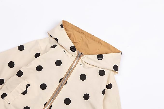 This girls' outerwear jackets offers two looks in one, featuring a playful polka dot pattern on one side and a classic solid color on the other